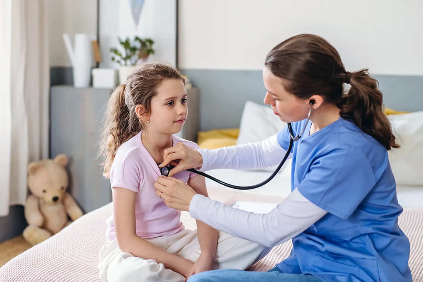 Female pediatrician is checking girl in hospital