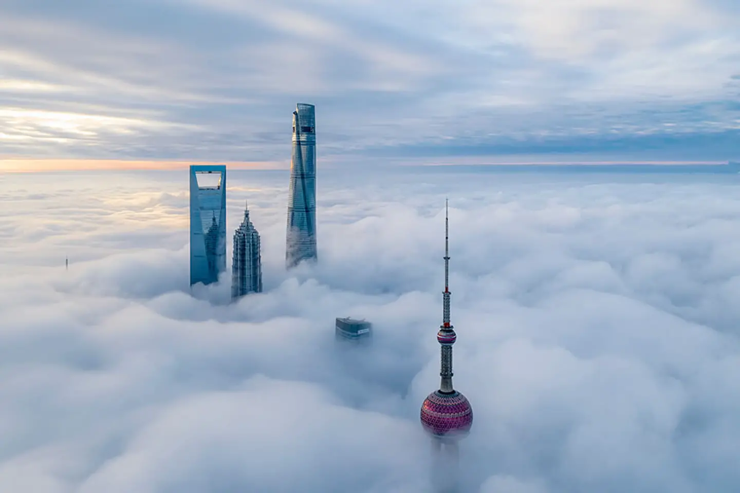 Some skyscrapers break through thick cloud cover