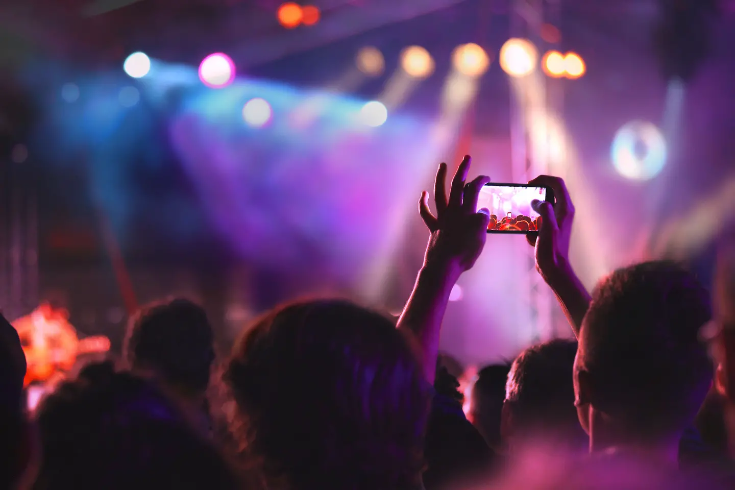 Man makes with the mobile photo during an event
